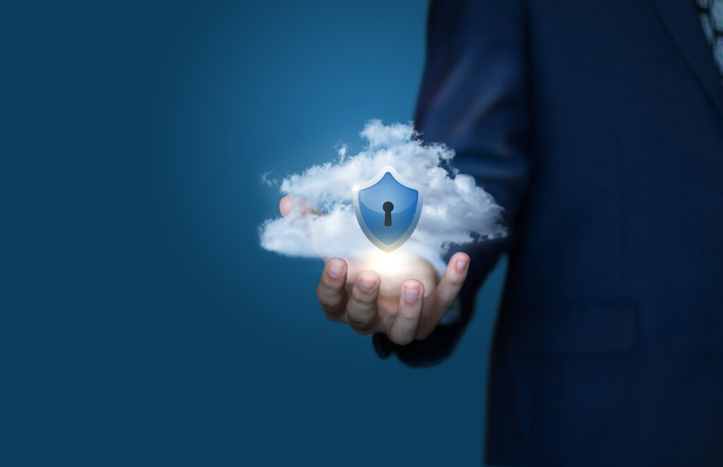 a lock sign is in middle of the cloud in a hand of a man wearing a blue coat